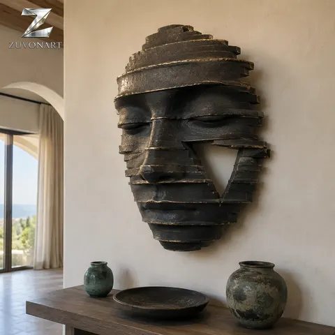 A closed-eye face emerges from layered, contour-like relief bands.