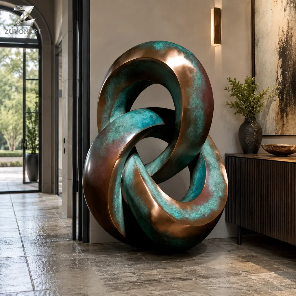 Two rounded linked loops create a compact composition with a patinated surface direction.