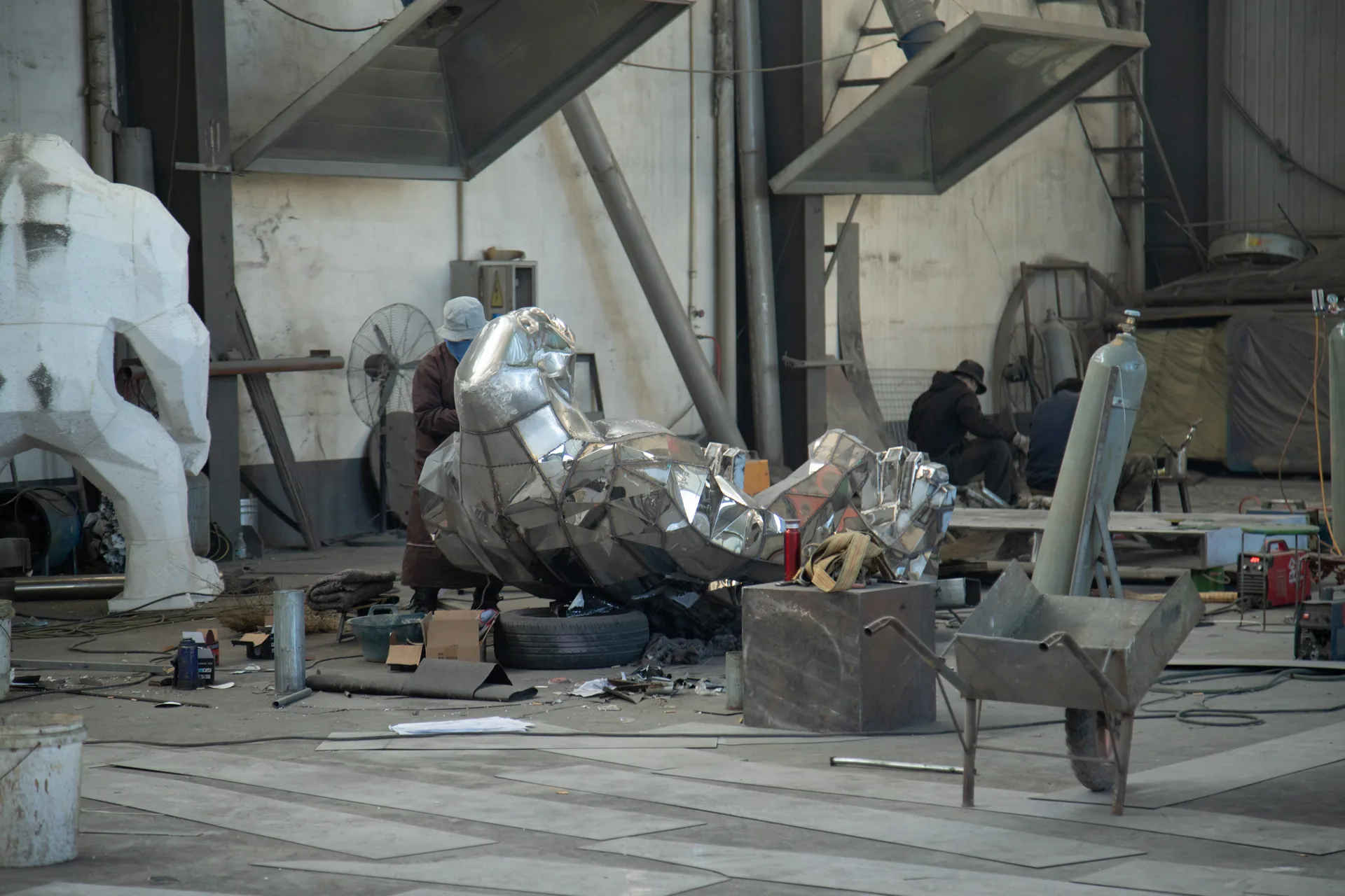 Steel lion sculpture being polished in the workshop